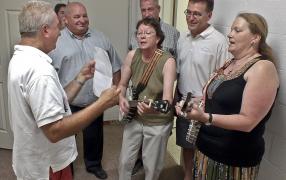 Museum supporters and local politicians enjoy a song to open the new accessible washroom.