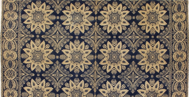 part of a blue and white woven coverlet