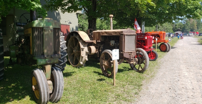 A row of antique tractors on display