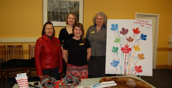 Craigleith Heritage Depot and LE Shore Memorial Library staff pose with a display about their programming.