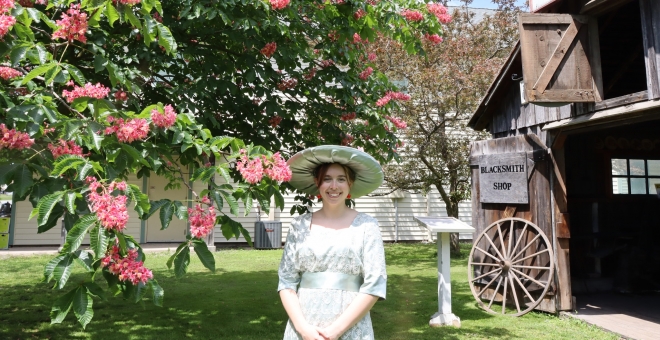 Young woman in Edwardian costume in heritage village