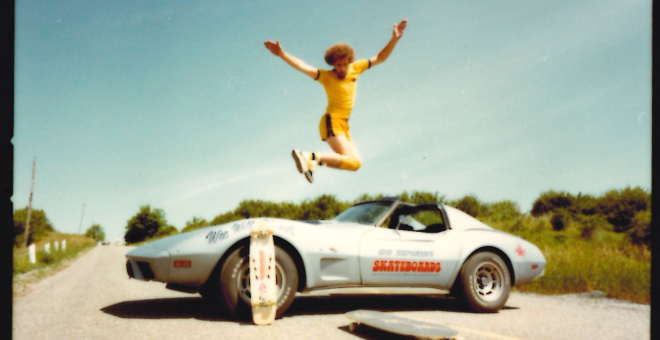 Willi Winkels jumps over a corvette before landing on a skateboard on the pavement