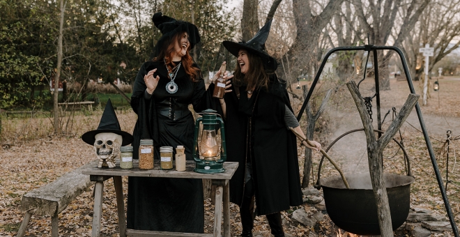 Two witches brewing a potion in a cauldron
