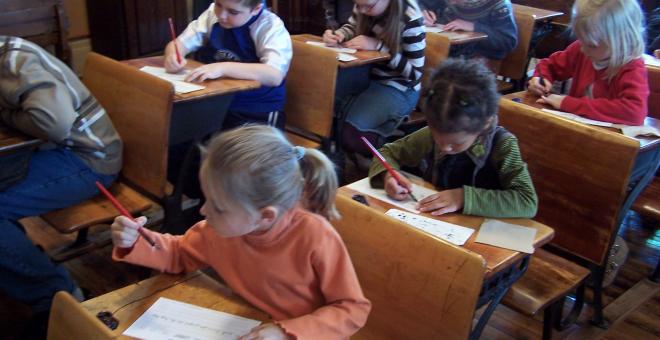 Children doing penmanship during the school program.