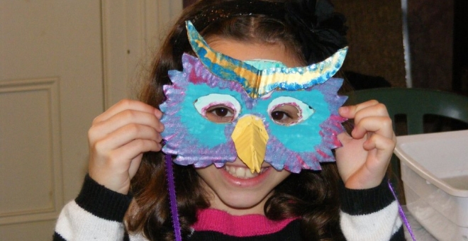 Avery shows off her colourful owl mask
