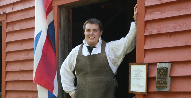Miller standing at door to Backhouse Mill